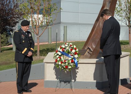 Army Lt. Gen. Frank Grass, U.S. Northern Command deputy commander, and Don Addy, National Homeland Defense Foundation president, hold a moment of silence at the North American Aerospace Defense Command and USNORTHCOM 9/11 remembrance ceremony at the commands' 9/11 Memorial Sept. 9. 