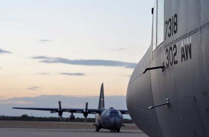 The sun sets beyond the Texas horizon as two C-130 Hercules remain ready for aerial firefighting support Sept. 10 at Austin-Bergstrom International Airport in Austin, Texas. Just hours before, Airmen assigned to units in Colorado and North Carolina arrived at the airport to form the 302nd Air Expeditionary Group, the Air Force's response to a U.S. Forest Service support request to aid in fighting wildfires. The 302nd AEG's mission is to provide aerial firefighting capabilities using the Modular Airborne Firefighting System, or "MAFFS" system.


