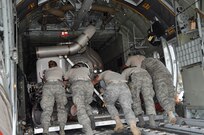 Air Force Reserve aerial porters with the 302nd Airlift Wing's 39th Aerial Port Squadron make the final push to load a U.S. Forest Service Modular Airborne Firefighting System II (MAFFS II) unit into a C-130 Sept. 9 at Peterson Air Force Base, Colo. The 302nd Airlift Wing has been tasked by U.S. Northern Command to provide two C-130s, aircrew and support personnel to supplement wildland firefighting efforts in Texas.

