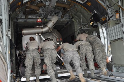 Air Force Reserve aerial porters with the 302nd Airlift Wing's 39th Aerial Port Squadron make the final push to load a U.S. Forest Service Modular Airborne Firefighting System II (MAFFS II) unit into a C-130 Sept. 9 at Peterson Air Force Base, Colo. The 302nd Airlift Wing has been tasked by U.S. Northern Command to provide two C-130s, aircrew and support personnel to supplement wildland firefighting efforts in Texas.

