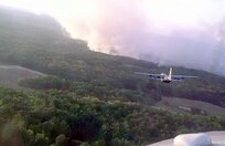 A Modular Airborne Firefighting System-equipped C-130 Hercules prepares for a fire retardant run over a wildfire Sept. 12 in Harrison County, Texas. Four MAFFS C-130 aircraft, assigned to the 302nd Air Expeditionary Group based at Austin-Bergstrom International Airport in Austin, Texas, provided approximately 12,000 gallons of retardant to two fires in the northeast Texas county.

