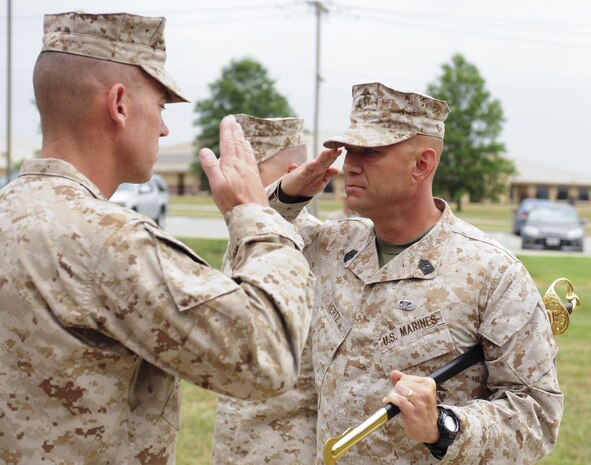 Sgt. Maj. Wayne A. Hertz, the outgoing Sergeant Major of 9th Marine Corps District, salutes Lt. Col. Michael D. Sherman, executive officer of 9MCD, during his Relief and Appointment ceremony at the district headquarters in Kansas City, Mo., July 26. Hertz relinquished the non-commissioned officer sword and the responsibilities as 9MCD Sergeant Major to Sgt. Maj. John S. Hawes.