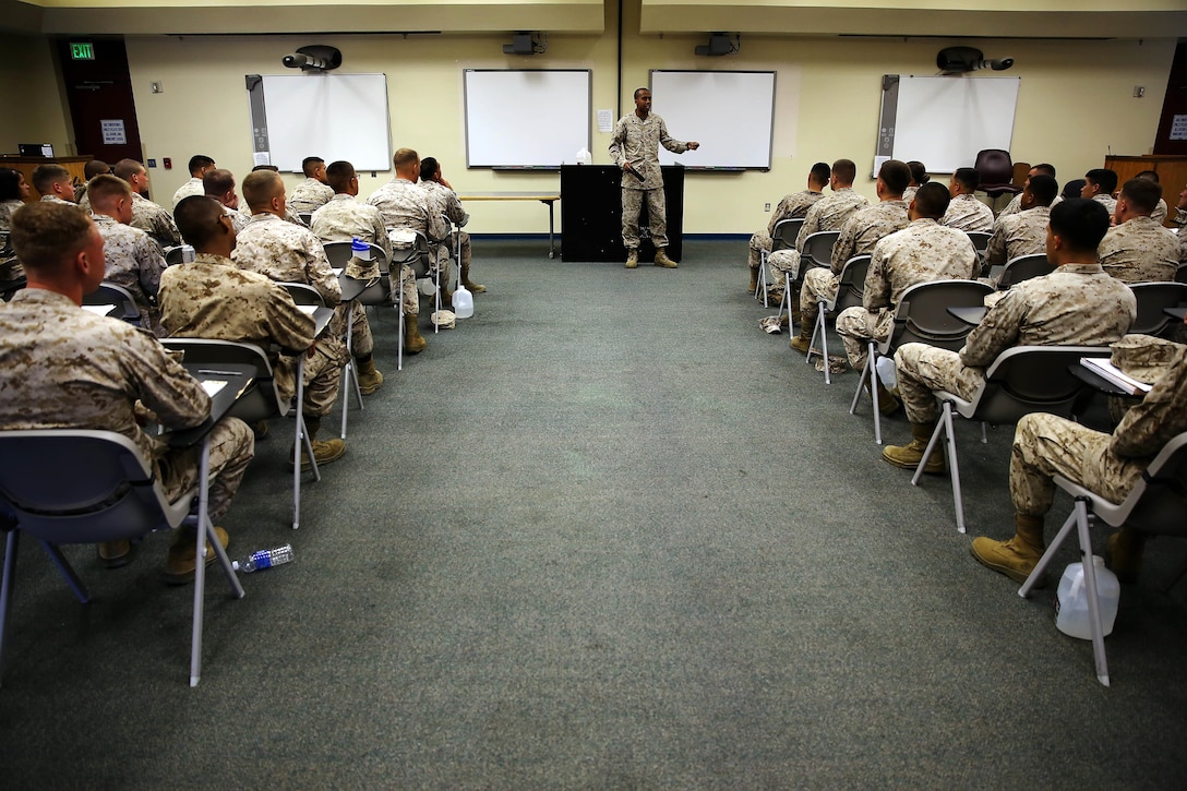 Sgt. Daniel J. Scott teaches 59 junior Marines during the Lance Corporal Seminar held at the Marine Corps Air Station here July 25.  Scott is an instructor for the course and an air traffic controller at the sir station. The Lance Corporal Seminar is a three-day course that the air station started this year to provide junior Marines with the knowledge and skills to progress in their military careers.  