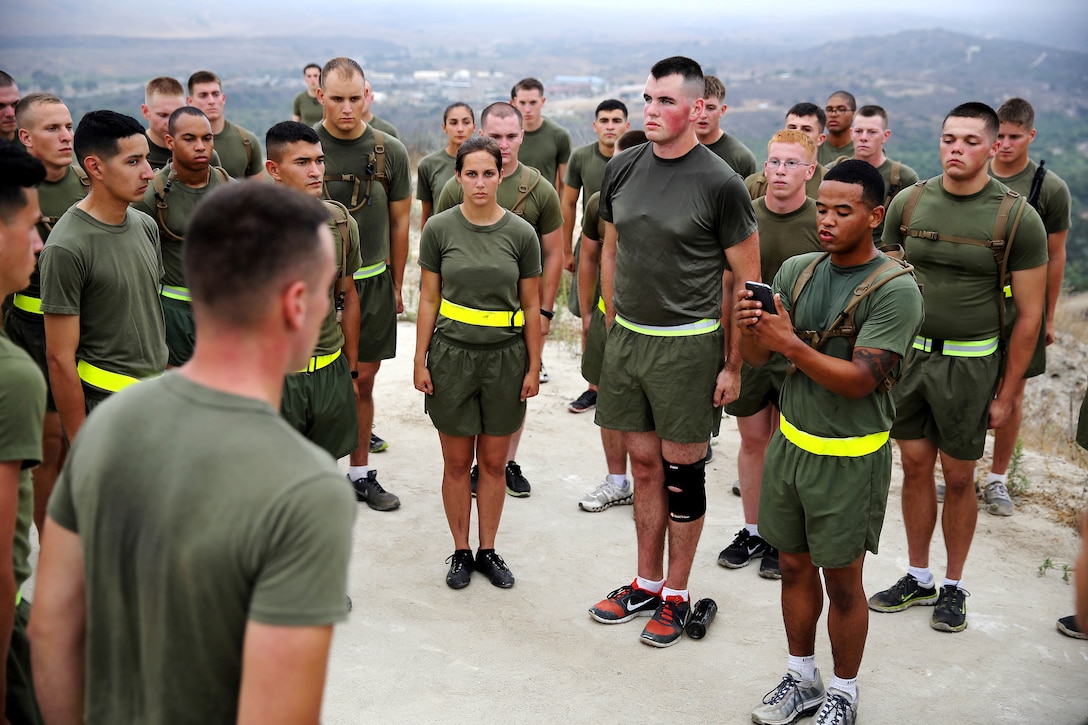 A Marine reads Gunnery Sgt. John Basilone’s Medal of Honor citation at a station during a morning physical fitness session at the Lance Corporal Seminar held at the Marine Corps Air Station here July 25. The Lance Corporal Seminar is a three-day course that the air station started this year to provide junior Marines with the knowledge and skills to progress in their military careers.