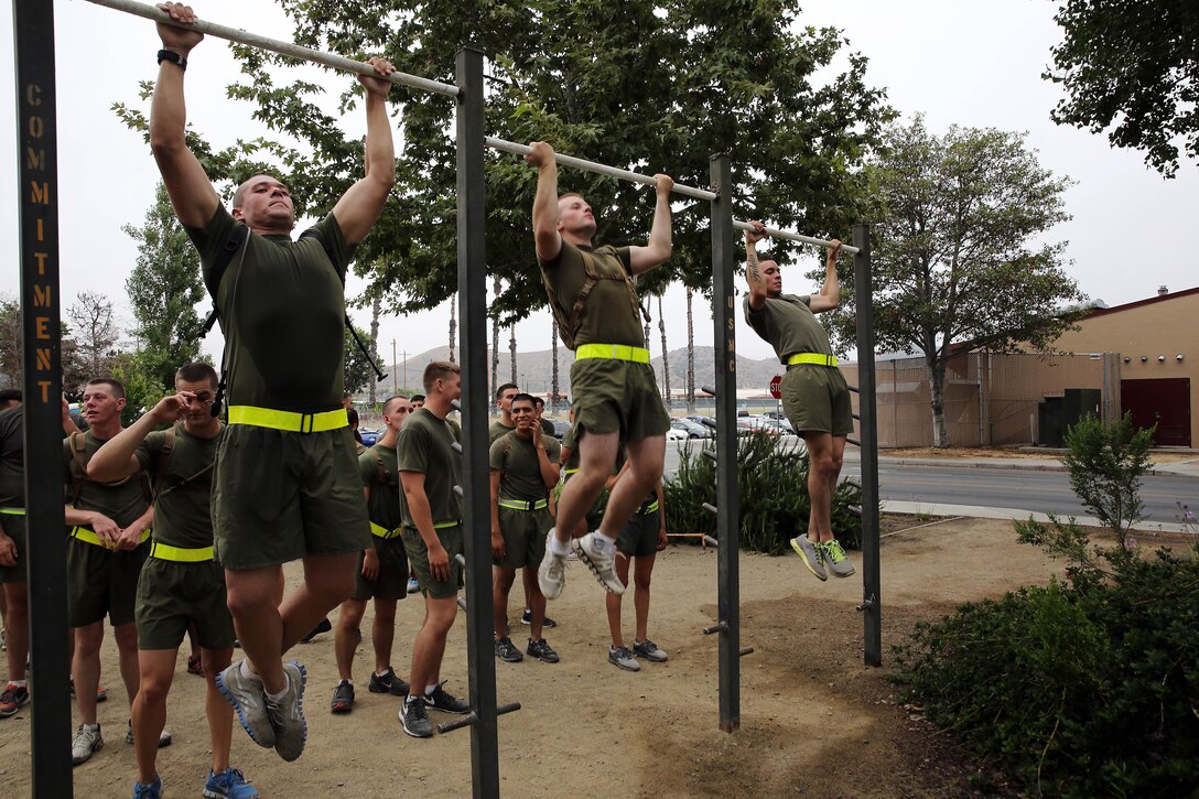 Marines do a max set of pull-ups after a morning physical fitness session during the Lance Corporal Seminar held at the Marine Corps Air Station here July 25. The Lance Corporal Seminar is a three-day course that the air station started this year to provide junior Marines with the knowledge and skills to progress in their military careers.
