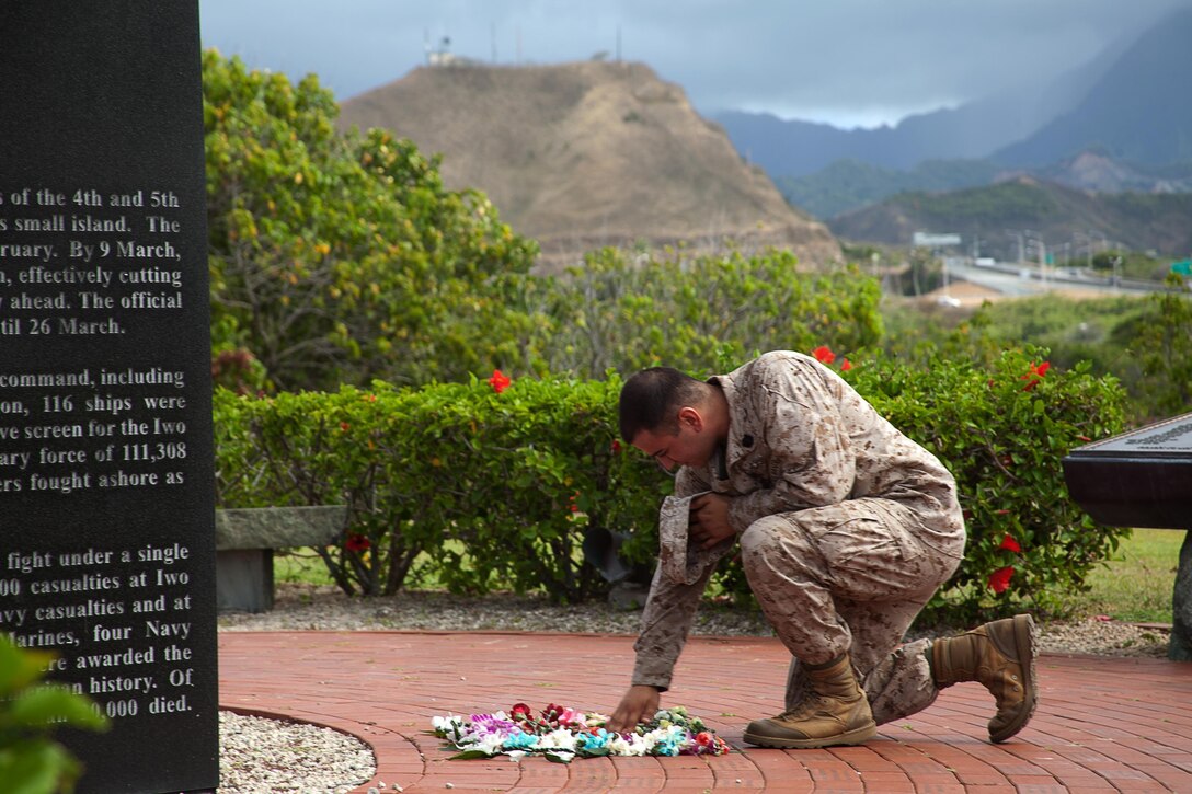 Petty Officer 2nd Class Farid Pezeshkian, 23, a corpsman with 3rd Marine Regiment, spends a moment gazing at the names of his friends after a brick-laying ceremony at the Pacific War Memorial, July 18, 2013.(U.S. Marine Corps photo by Lance Cpl. Nathan Knapke) 