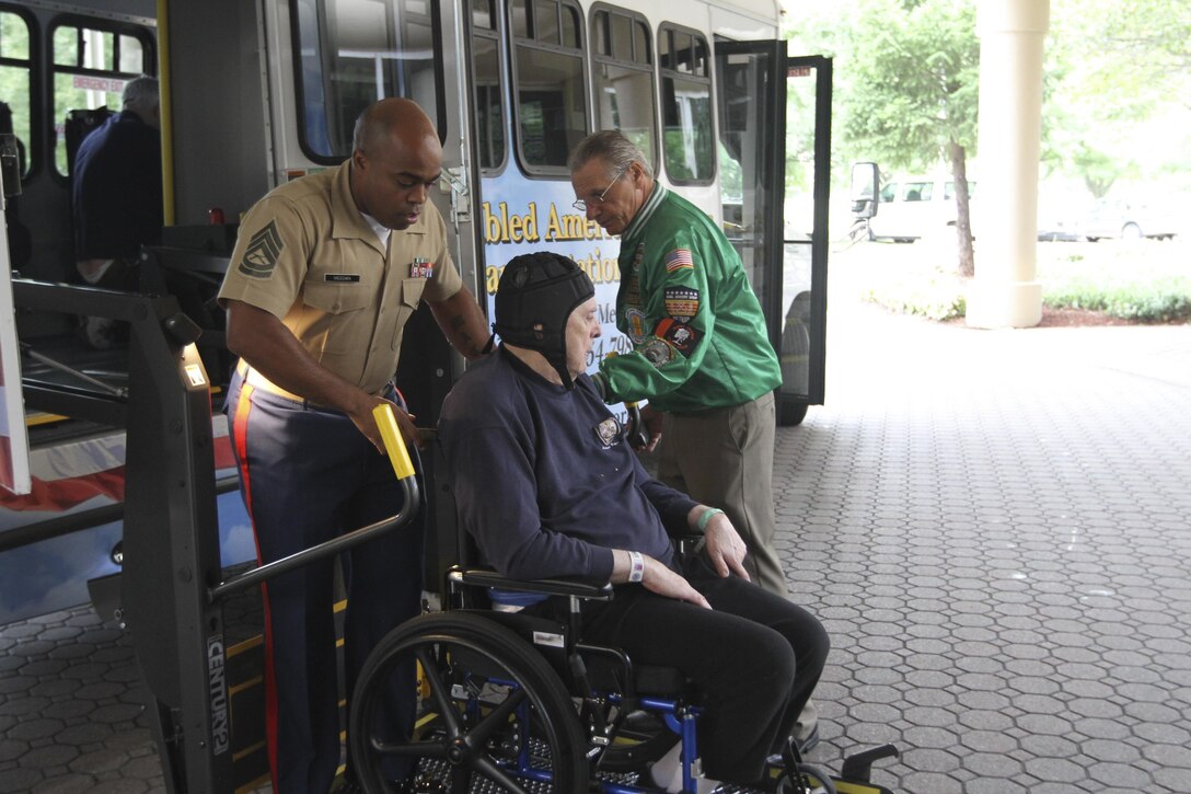 Gunnery Sgt. Dean A. McCown, the company gunnery sergeant and the information systems management officer of 1st Marine Corps District, assists a veteran to his vehicle after the Korean War Commemorative Breakfast at the Marriott hotel in Melville July 26. The event brought together service members of the past and present to remember those who gave the ultimate sacrifice for their country. (U.S. Marine Corps photo by Cpl. Daniel E. Valle/Released)