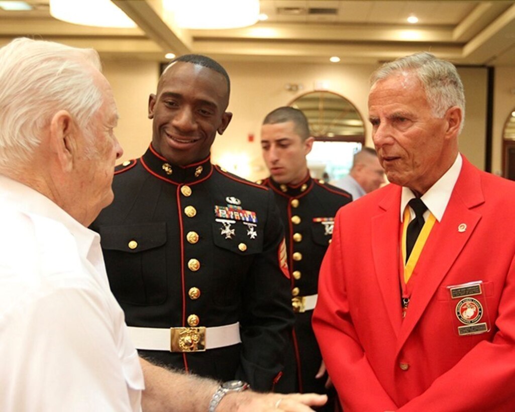 Sgt. Malik S. King, the colors sergeant of 1st Marine Corps District, and William Ober, the commandant of Marine Corps League Detachment 792, listen to a veteran speak about his experience in the service during a Korean War Commemorative Breakfast at the Marriott hotel in Melville July 26. The event brought together service members of the past and present to remember those who gave the ultimate sacrifice for their country. (U.S. Marine Corps photo by Pfc. Brandon M. Thomas/Released)