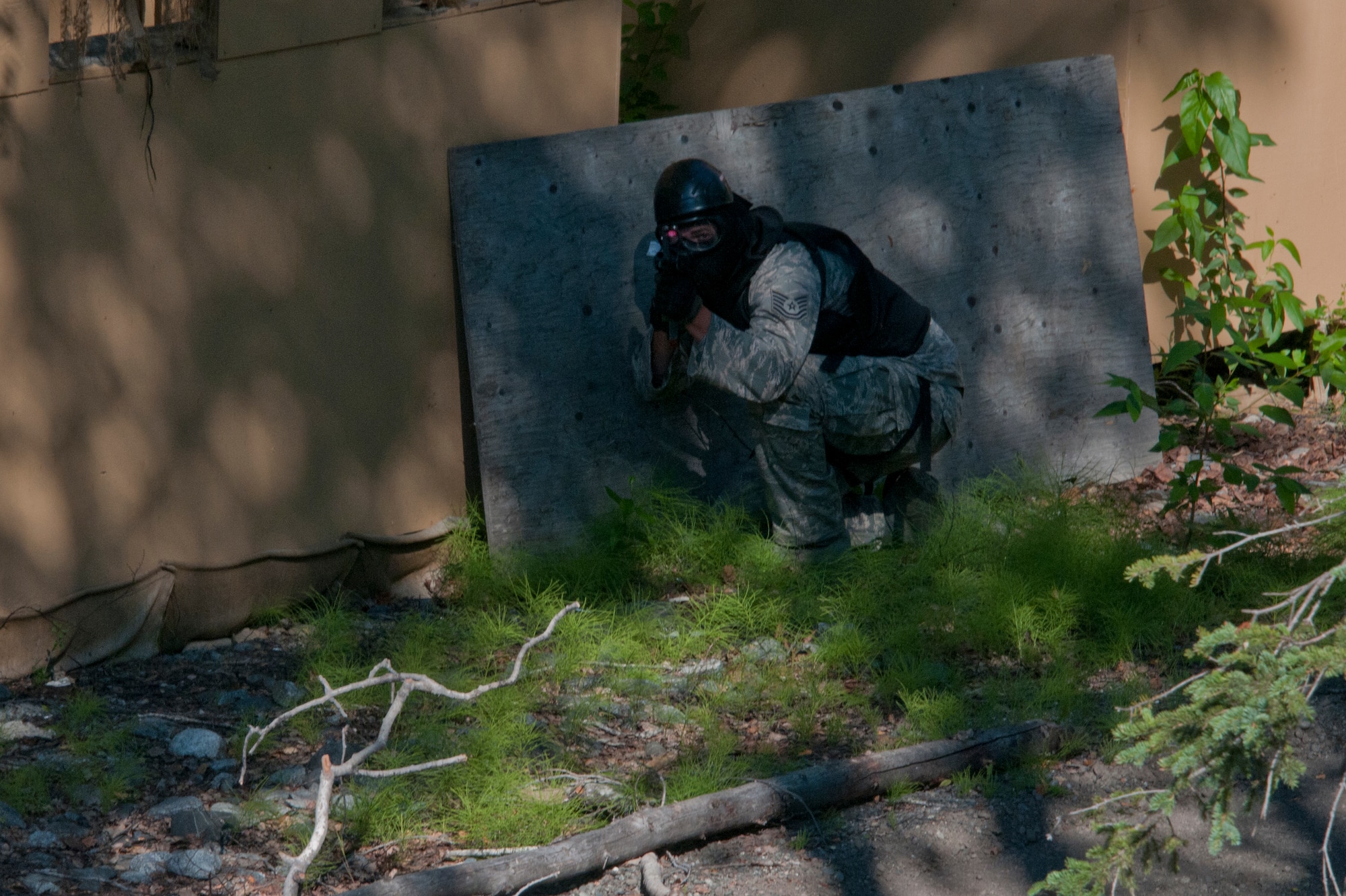 JOINT BASE ELMENDORF-RICHARDSON, Alaska -- An Ohio Air Guardsmen spies a roof-top shooter during squad movement tactics and react-to-contact training under the Alaska Air National Guard's security forces trainers here July 24, 2013. Fifteen members of the 179th Security Forces Squadron, Ohio Air National Guard, along with 28 other members of their wing, performed annual training here. (U.S. Air National Guard photo by Staff Sgt N. Alicia Halla/Released)