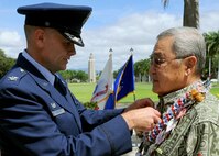 Col. Johnny Roscoe, 15th Wing commander, pins a Bronze Star on former U.S. Army Capt. Myron “Skip” Kawakami during his decoration ceremony at the 15th WG headquarters building on Joint Base Pearl Harbor-Hickam, Hawaii, July 26, 2013. The Bronze Star Medal is an individual military award of the United States Armed Forces. It may be awarded for acts of heroism, acts of merit, or meritorious service in a combat zone.  (U.S. Air Force photo/Tech. Sgt. Jerome S. Tayborn)