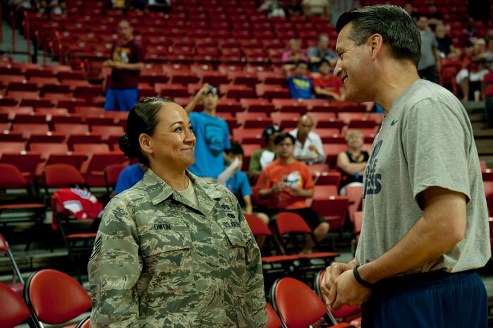 Nevada Governor, Brian Sandoval, talks with Staff Sgt. Rebecca Owen, United States Air Force Warfare Center paralegal, before the USA Blue vs. White Basketball game July 25, 2013, at the Thomas and Mack Center in Las Vegas. Owen was joined by two other Airmen who recently returned from deployment and a Wounded Warrior. (U.S. Air Force photo by Senior Airman Daniel Hughes) 