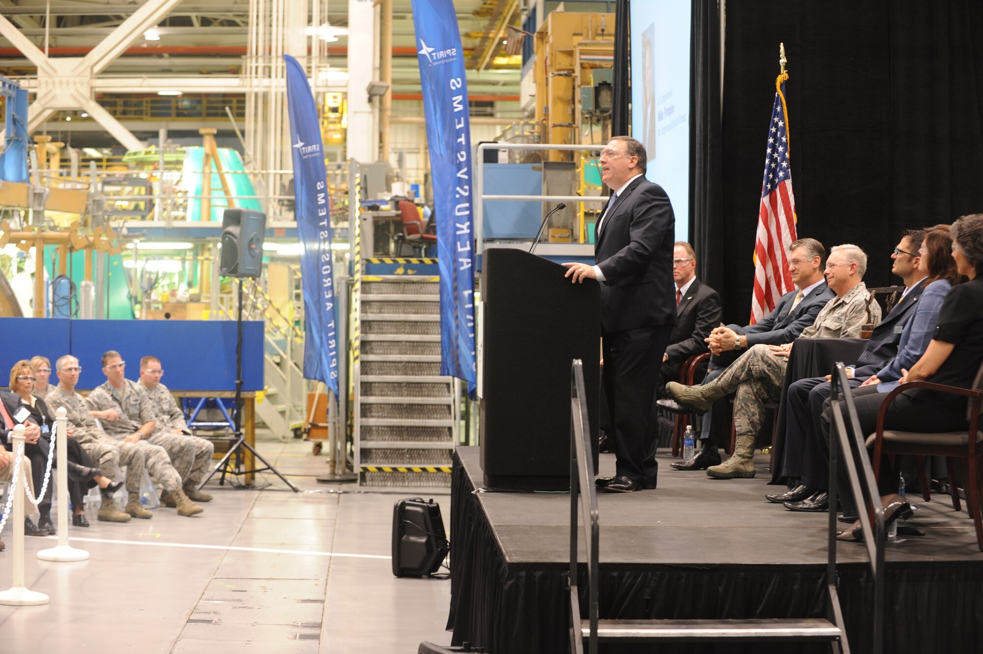 Larry Lawson, Spirit AeroSytsems president and CEO, presents production plans to guests of the KC-46A Forward Fuselage Rollout July 26, 2013, in Wichita, Kan.  Approximately 200 people attended the revealing of the operations center section of the aircraft, which is slated to replace the Air Force’s leading air refueling platform, the KC-135 Stratotanker.  (U.S. Air Force photo/Airman 1st Class John Linzmeier)