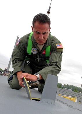 U.S. Air Force Airman 1st Class John Aguilar Porrata-Doria, 317th Aircraft Maintenance Squadron, inspects the top of the aircraft on the 317th Airlift Groups newest C-130J July 24, 2013, at the Lockheed Martin flight line in Marietta, Ga. Airmen from the 317th AG inspected the new aircraft before accepting it and flying it back to Dyess Air Force Base, Texas. (U.S. Air Force photo by Airman 1st Class Peter Thompson/Released)