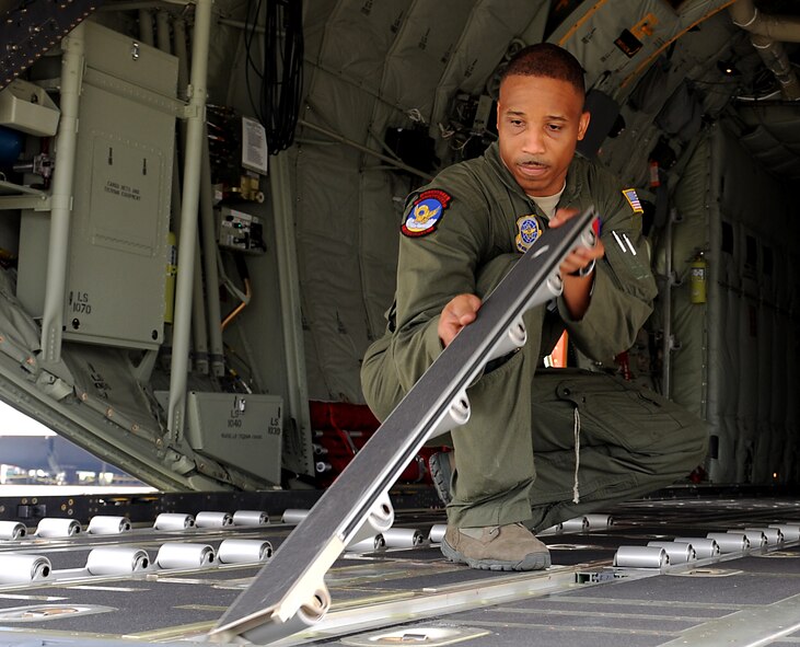 U.S. Air Force Master Sgt. Robert Furbush, 39th Airlift Squadron reconfigures aircraft rollers on the 317th Airlift Groups newest C-130J July 24, 2013, at the Lockheed Martin flight line in Marietta, Ga. The final C-130J completes the 317th AG fleet of 28 aircraft, making it the largest C-130J fleet in the world. (U.S. Air Force photo by Airman 1st Class Peter Thompson/Released)