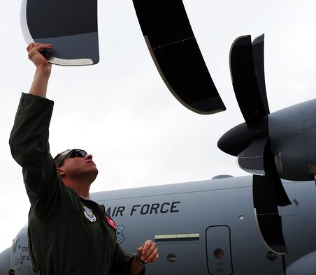 U.S. Air Force Airman 1st Class John Aguilar Porrata-Doria, 317th Aircraft Maintenance Squadron, inspects the propeller blades on the 317th Airlift Groups newest C-130J July 24, 2013, at the Lockheed Martin flight line in Marietta, Ga. A crew of six Airmen from the 317th AG traveled to Lockheed Martin’s production facility to pick up the units newest C-130J. (U.S. Air Force photo by Airman 1st Class Peter Thompson/Released)
