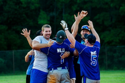 Players from the 437th Maintenance Squadron celebrate after winning the Intramural Softball Championship Game July 24, 2013, at Joint Base Charleston – Air Base, S.C. 437th MXS defeated the 628th Security Forces Squadron 14 -11. (U.S. Air Force photo/Senior Airman George Goslin)