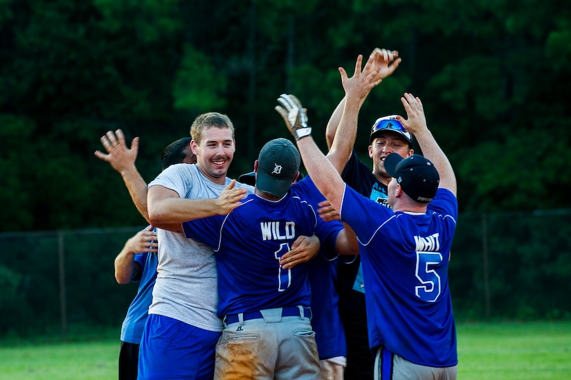 Players from the 437th Maintenance Squadron celebrate after winning the Intramural Softball Championship Game July 24, 2013, at Joint Base Charleston – Air Base, S.C. 437th MXS defeated the 628th Security Forces Squadron 14 -11. (U.S. Air Force photo/Senior Airman George Goslin)