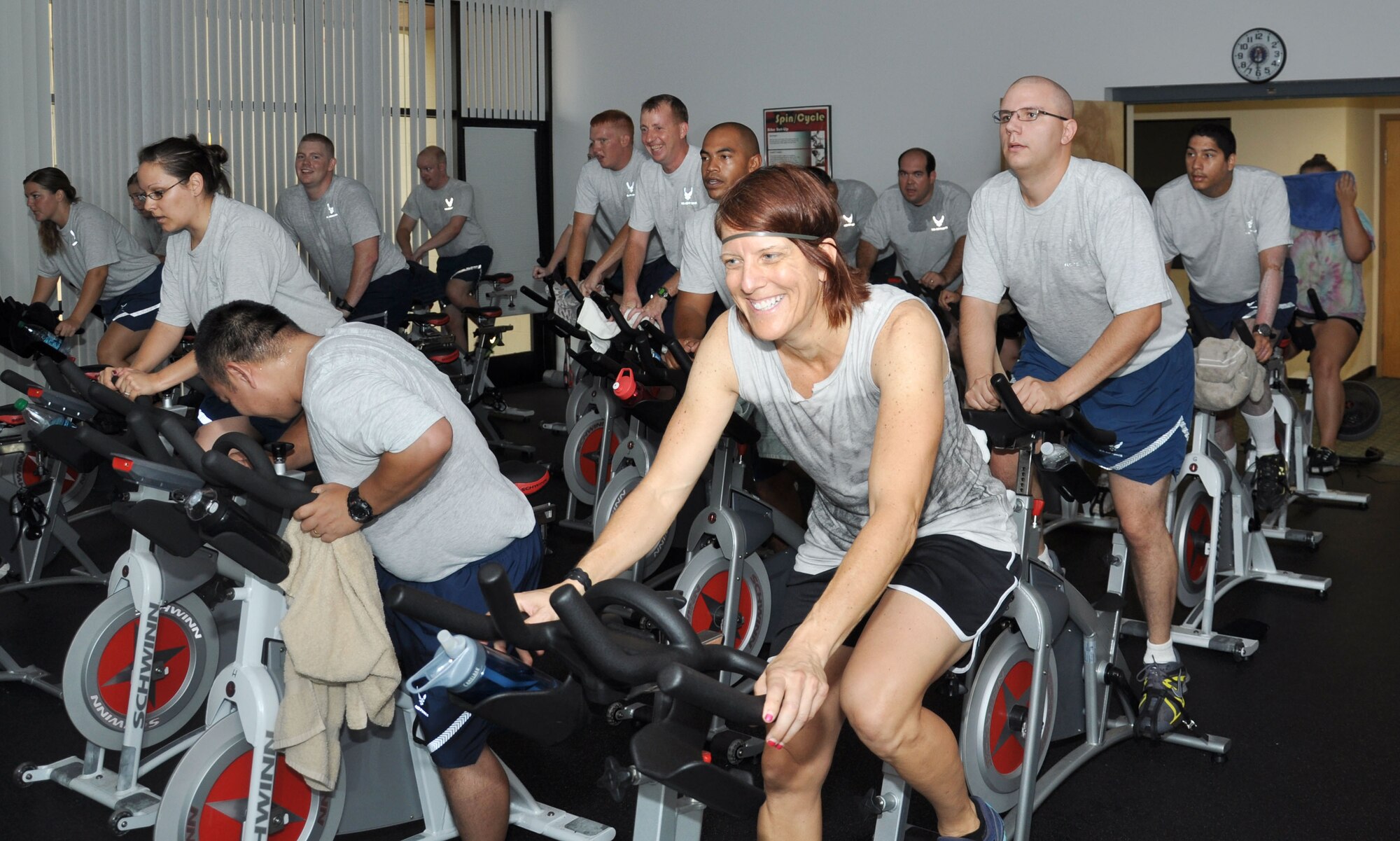 Marlyn Shults, 56th Aerospace Medicine Squadron exercise physiologist, participates in a spin class with Airmen July 17 at the 56th AMDS Health and Wellness Center. The class is part of the running clinic, a six-week-long program designed to improve fitness test scores. (U.S. Air Force photo/Staff Sgt. Luther Mitchell Jr.)