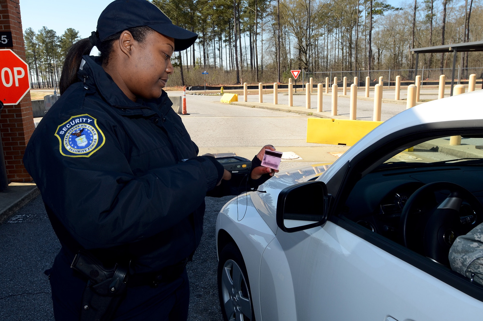 Ms. Veronica Dennis, security forces personnel with the 169th Security Forces Squadron at McEntire Joint National Guard Base, S.C., checks ID cards at the main gate entrance using the Defense Biometric Identification System scanner, March 28, 2013.
(U.S. Air National Guard photo by Tech. Sgt. Caycee Watson/Released)