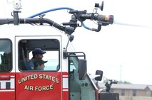 YOUNGSTOWN AIR RESERVE STATION, Ohio -- The 910th Airlift Wing's 54th Pilot for a Day, honorary 2nd Lieutenant Nicholas Greathouse, sprays water from a station fire truck with the help of base firefighters, here, July 24. Pilot for a Day is a community outreach program that works through Akron Children's Hospital Boardman to welcome children with chronic or life-threatening illnesses to the station for a day of military experiences. U.S. Air Force photo by TSgt. Jim Brock.