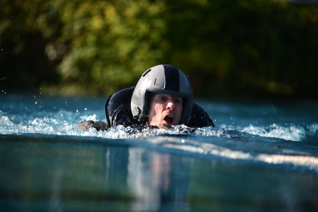 Lt. Col. Steve Horton stays afloat while being dragged by a parachute harness during water survival training July 19, 2013, at Spangdahlem Air Base, Germany. Pilots must learn how to disengage from a parachute while being dragged across open water by the wind to ensure their safety in real-world situations. Horton is the 52nd Operations Group deputy commander. (U.S. Air Force photo/Airman 1st Class Gustavo Castillo) 