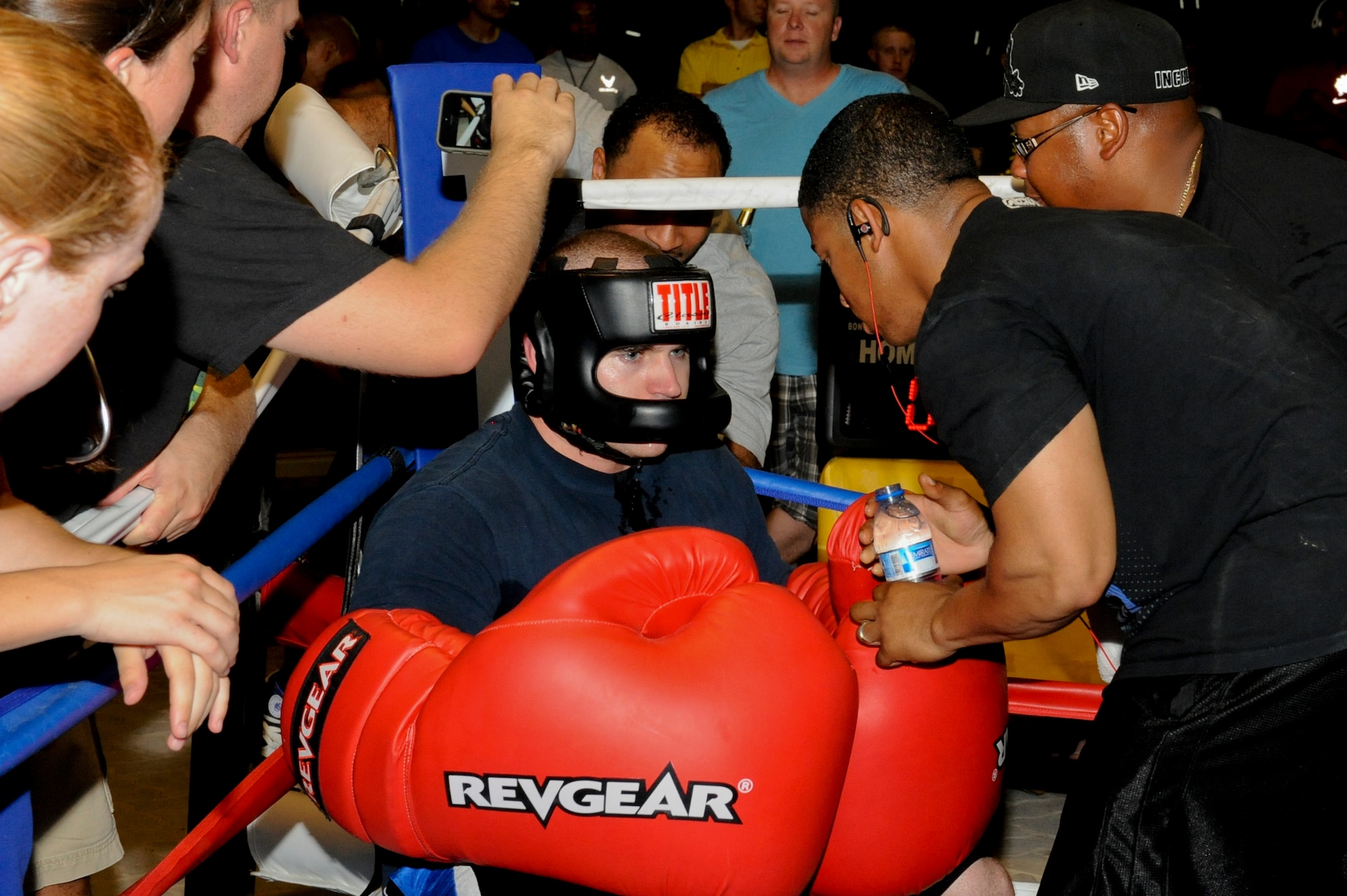 U.S. Air Force Staff Sgt. Charles Canfield, 380th Expeditionary Communication Squadron, talks to his corner man U.S. Air Force Staff Sgt. Dante Lewis, 380th ECS, in-between rounds of a big glove boxing match at an undisclosed location Southwest Asia July 19, 2013.  Lewis advises Canfield on strategies for the remaining rounds in the fight. Canfield is deployed from Ellsworth, S.D., and Lewis is deployed from Joint Base Langley-Eustis, Va. (U.S. Air Force photo by Staff Sgt. Joshua J. Garcia)