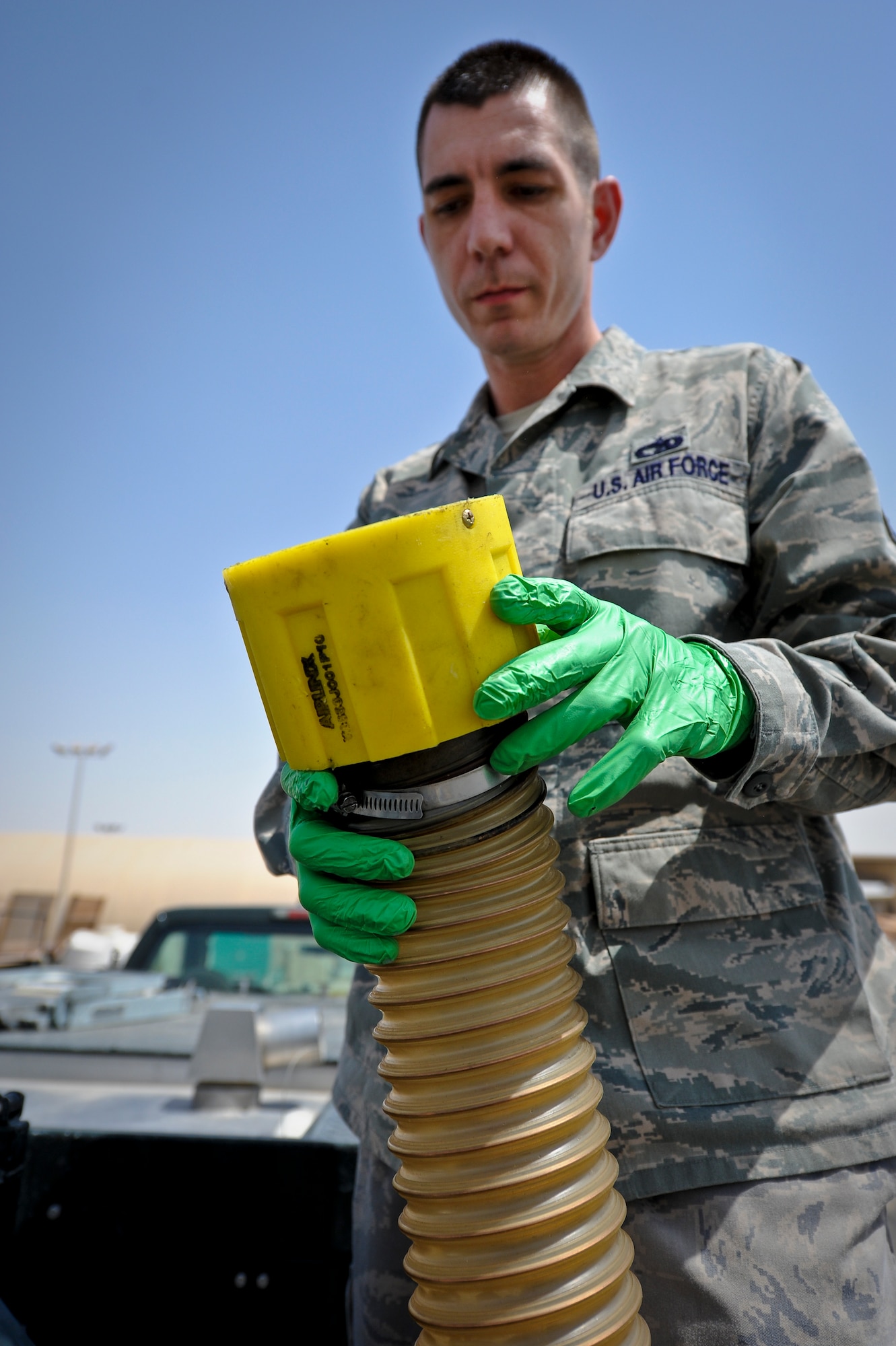 Tech. Sgt. Christopher Breski inspects the "moose head" nozzle at the end of a waste retrieval hose used by the lavatory service truck at the 379th Air Expeditionary Wing in Southwest Asia, July 22, 2013. Breski is the 8th Expeditionary Air Mobility Squadron fleet services NCO in charge deployed from Joint Base McGuire-Dix-Lakehurst, N.J. (U.S. Air Force photo/Senior Airman Benjamin Stratton)