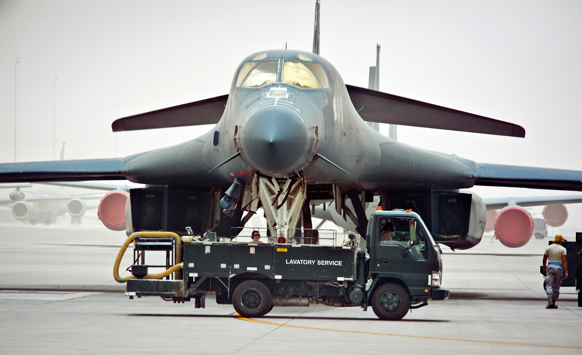 Airmen from the 8th Expeditionary Air Mobility Squadron fleet services remove waste from a 34th Expeditionary Bomb Squadron B-1B Lancer at the 379th Air Expeditionary Wing in Southwest Asia, June 11, 2013. Once an aircraft comes to the flightline, the lavatory service truck goes out to the aircraft and attaches a pipe to the plane with what they call the "moose head" for a nozzle. A handle is pulled releasing the waste which then flows through the pipe and into the truck. Not only do these Airmen care for Air Mobility Command aircraft, but are the only fleet services unit in the U.S. Central Command's area of responsibility taking care of any aircraft transiting through the 379th AEW. (U.S. Air Force photo/Senior Airman Benjamin Stratton)