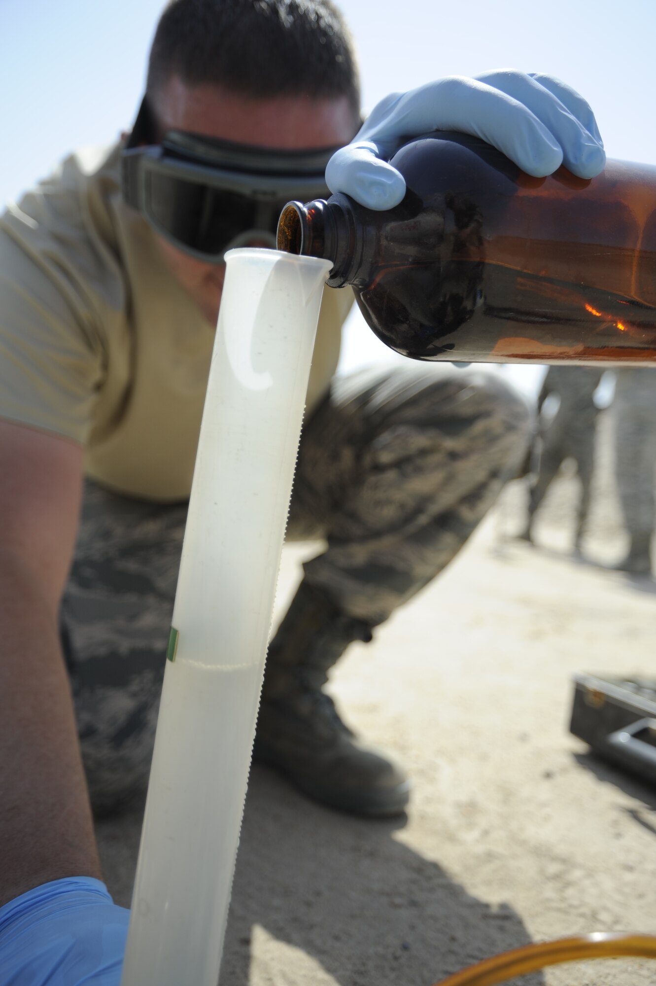 Staff Sgt. Robert Bradley, 386th Expeditionary Logistics Readiness Squadron, fuels laboratory technician, prepares to test the levels of Fuels System Icing Inhibitor injected into the squadron’s first shipment of Jet A1 fuel here, July 16, 2013. The 386th Air Expeditionary Wing has joined many other Air Force units in making the switch from JP8, military specification fuel, to commercial fuel.  Bradley and other members of the fuels flight are responsible for injecting the additives needed to get the Jet A1 fuel ready for use in the base’s aircraft.  Bradley, a native of Knob Noster, Mo., is deployed out of Kadena Air Base, Japan.  (U.S. Air Force photo by Master Sgt. Christopher A. Campbell)