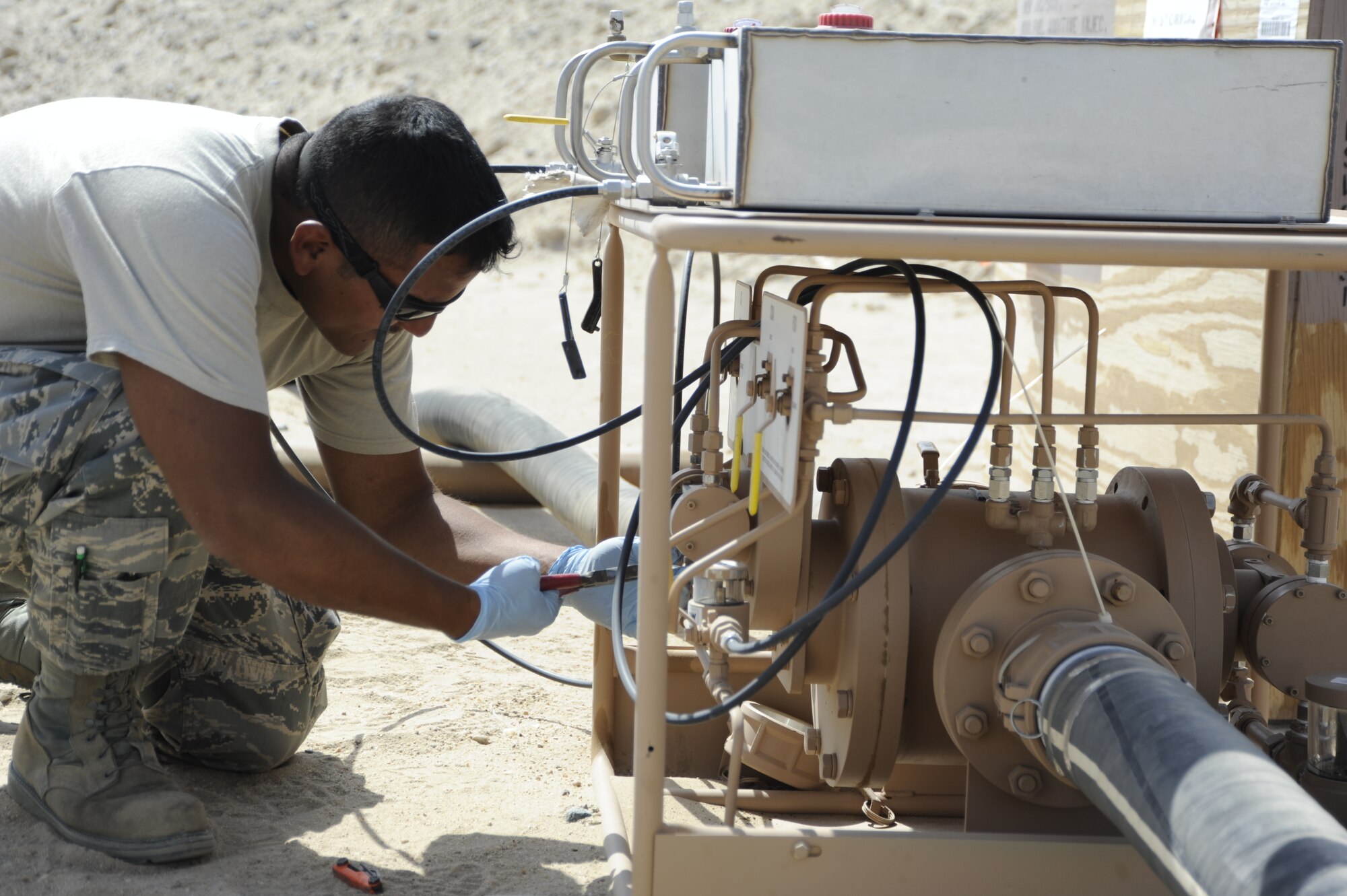 Senior Airman Jesse Silva, 386th Expeditionary Logistics Readiness Squadron, bulk storage attendant, adjusts the knobs on a Hammonds Additive Injector here, July 16, 2013.  Silva does this to regulate how much additive is injected into the fuel, the squadron’s first delivery of Jet A1. The 386th Air Expeditionary Wing has joined a list of many other Air Force units making the switch from JP8, military specification fuel, to commercial fuel.  In order to prepare the Jet A1 fuel for use in military aircraft, Silver overseas the injection of two additives, the fuels system icing inhibitor to help prevent water in the fuel from freezing and the corrosion inhibitor/lubricity improver.  Silva is deployed out of the Atlantic City, N.J., Air National Guard unit.  (U.S. Air Force photo by Master Sgt. Christopher A. Campbell)
