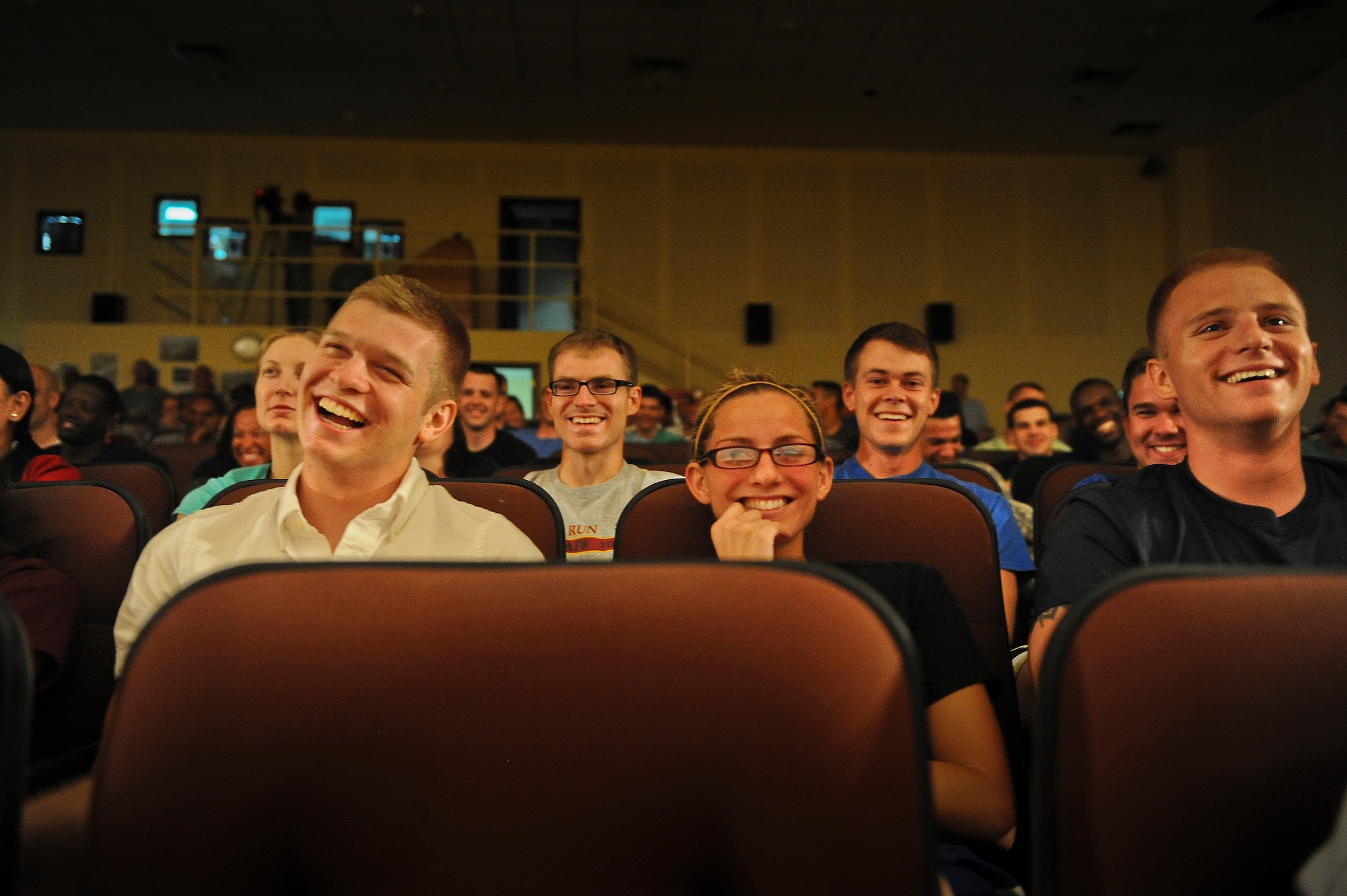 Airmen deployed to an undisclosed location in Southwest Asia laugh at a joke by Comedienne Laura Hayden during her performance Saturday, July 20, 2013, as part of the Don Barnhart All-Star Comedy tour.  (U.S. Air Force Photo by 1st Lt. Nathan Wallin)
