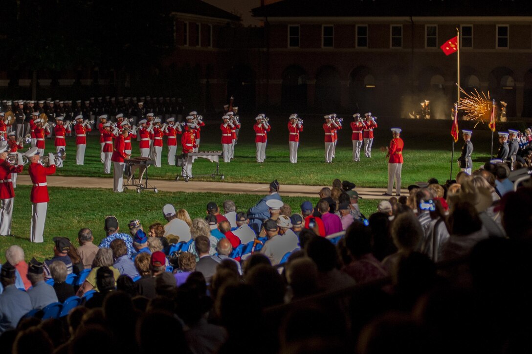 Guests watch the body bearers fire 40mm cannons while the U.S. Marine Drum & Bugle Corps plays "Ode to Joy" during a parade in remembrance of the Korean War at Marine Barracks Washington, D.C., July 25. 