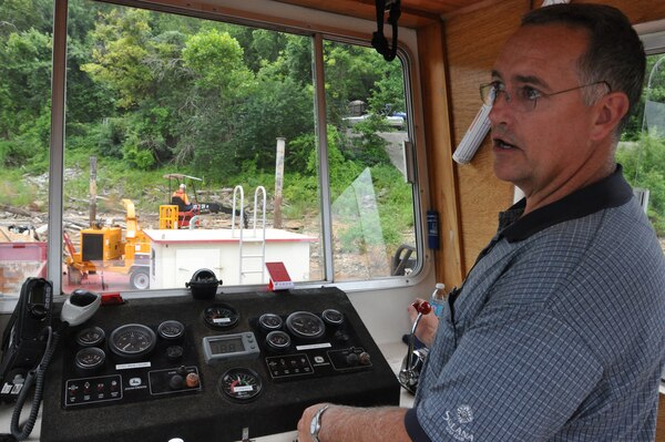 Rodney Koger, the PRIDE captain explains the procedures and manuvers of how the “PRIDE of the Cumberland,” a vessel operated by the U.S. Army Corps of Engineers, Nashville District cruises Lake Cumberland's shorelines and waterways keeping it clean and free of logs, trash and debris.    