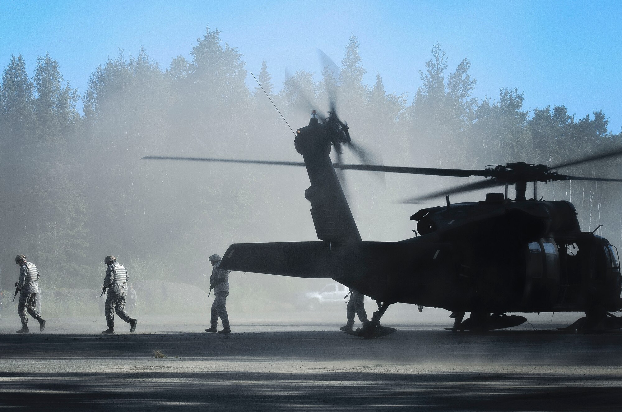 JOINT BASE ELMENDORF-RICHARDSON, Alaska -- Guardsmen from the 179th Security Forces, Ohio Air National Guard, exit a Black Hawk helicopter from the 1st Battalion, 207th Aviation Regiment, Alaska Army National Guard, on Joint Base Elmendorf-Richardson July 24. The Ohio Guardsmen were practicing insertion techniques that is important for deployment preparation during their annual training. U.S. Army National Guard image by Sgt. Edward Eagerton/Released