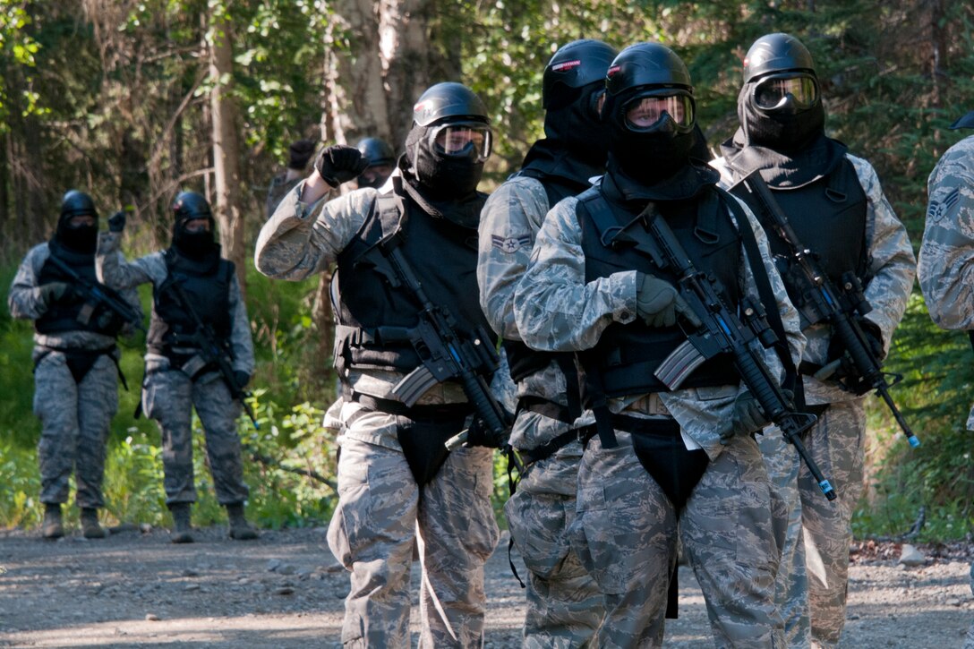 JOINT BASE ELMENDORF-RICHARDSON, Alaska -- Ohio Air Guardsmen practice squad movement tactics and react-to-contact training under the Alaska Air National Guard's security forces trainers here July 24, 2013. Fifteen members of the 179th Security Forces Squadron, Ohio Air National Guard, along with 28 other members within their wing, performed annual training here. (U.S. Air National Guard photo by Staff Sgt N. Alicia Halla/Released)