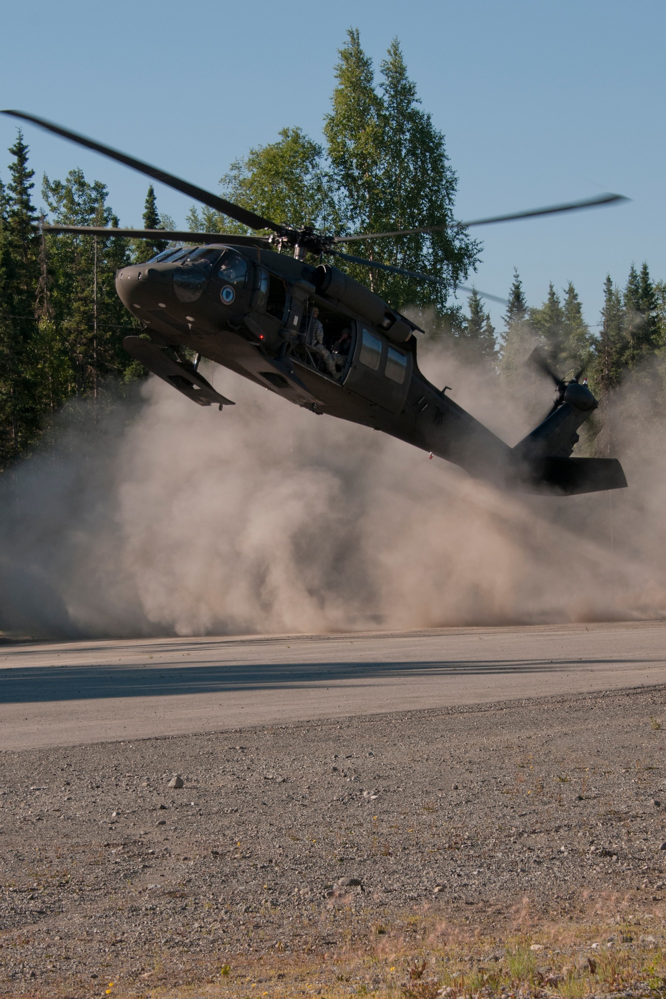 JOINT BASE ELMENDORF-RICHARDSON, Alaska -- Ohio Air Guardsmen practice tactical helocopter insertion on a UH-60 Black Hawk with Alaksa Army National Guard pilots from the 1st Battalion, 207th Aviation Regiment, here July 24, 2013. Fifteen members of the 179th Security Forces Squadron, Ohio Air National Guard, along with 28 other squadron members within their wing, performed their two-week annual training here. (U.S. Air National Guard photo by Staff Sgt N. Alicia Halla/Released)