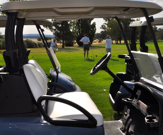 Golfers play a round of golf at the Coyote Run Golf Course at Beale Air Force Base, Calif. on July 23, 2013. The golfers were some of the first customers to experience one of the 76 new golf carts. (U.S. Air Force photo by 2nd Lt. Siobhan Bennett)