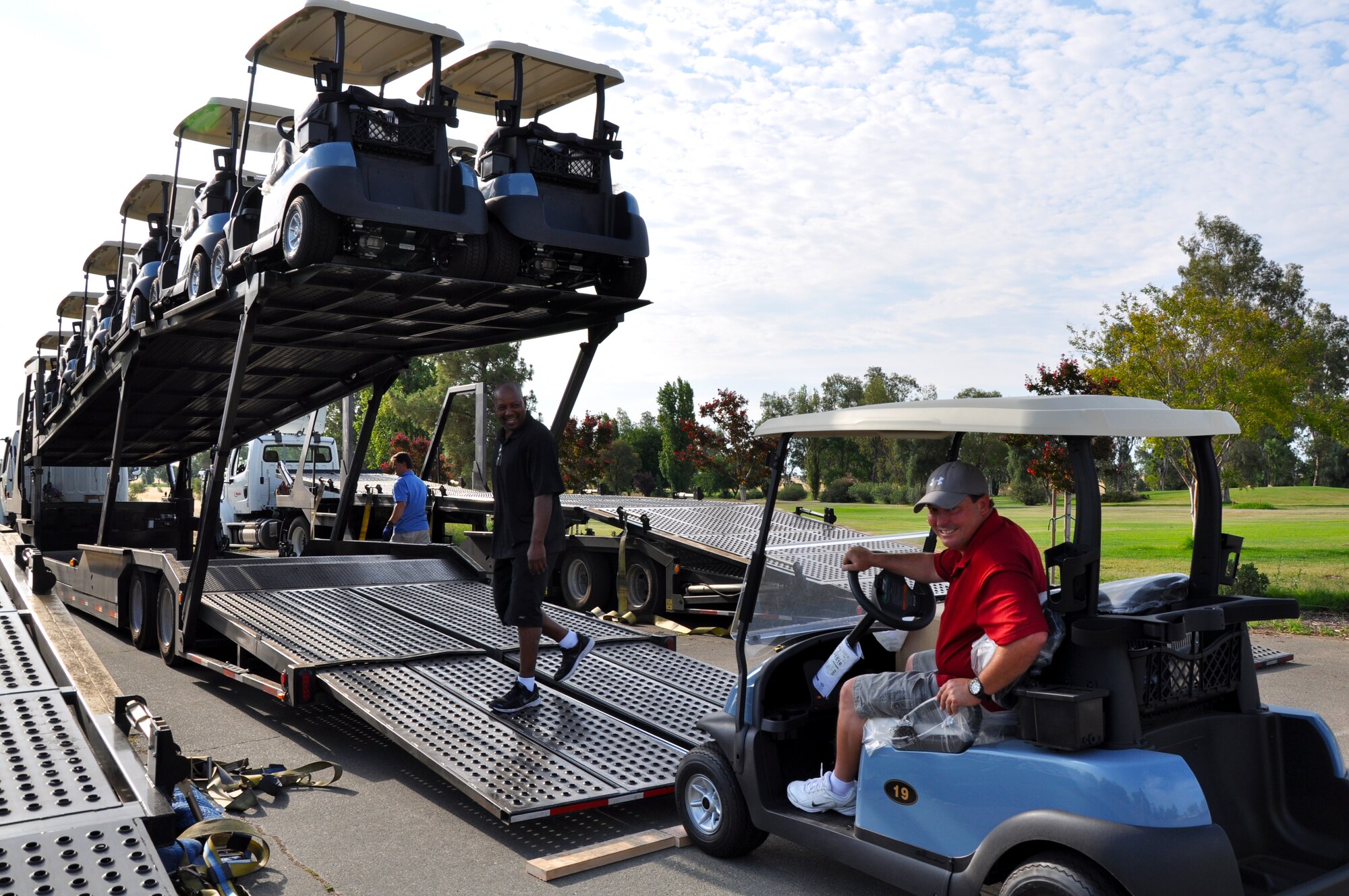 Workers at Coyote Run Golf Course unload new golf carts on July 23, 2013 at Beale Air Force Base, Calif. All 76 new golf carts were financed through the normal 9th Force Support Squadron and paid for through the Non-appropriated Funding Council after approval from the Wing. (U.S. Air Force photo by 2nd Lt. Siobhan Bennett/Released)   