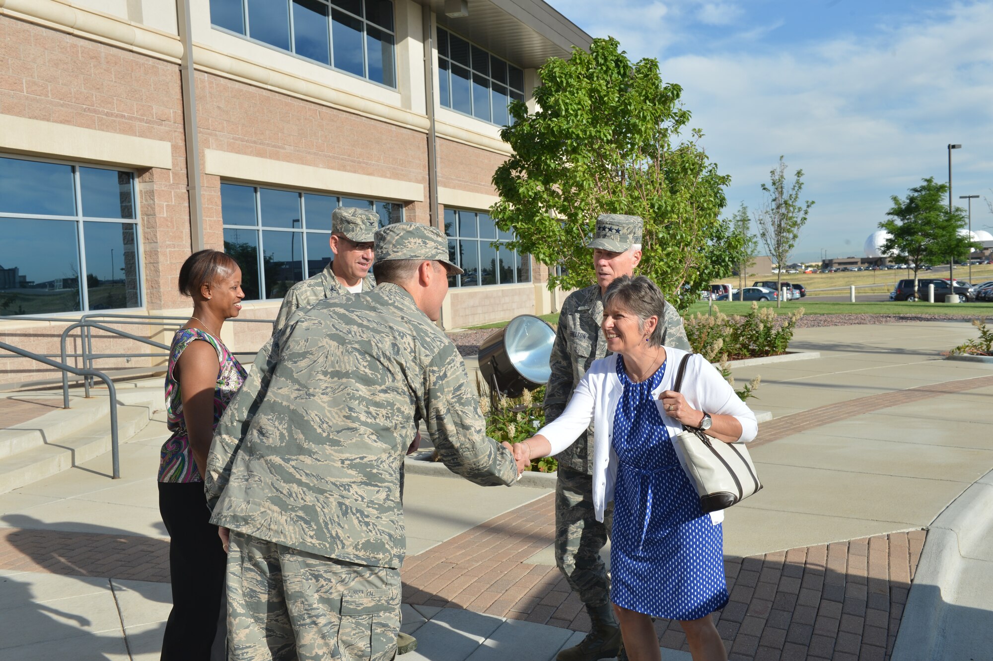 Col. Dan Wright, 460th Space Wing commander; his wife, Travelle; and Col. Mitch D. Stratton, 460th SW vice commander, greet Gen. William Shelton, Air Force Space Command commander; and his wife, Linda, July 23, at the 460th SW headquarters building on Buckley Air Force Base, Colo. Shelton received a tour of the base and an update on current operations. (U.S. Air Force photo by Staff Sgt. Paul Labbe/Released)