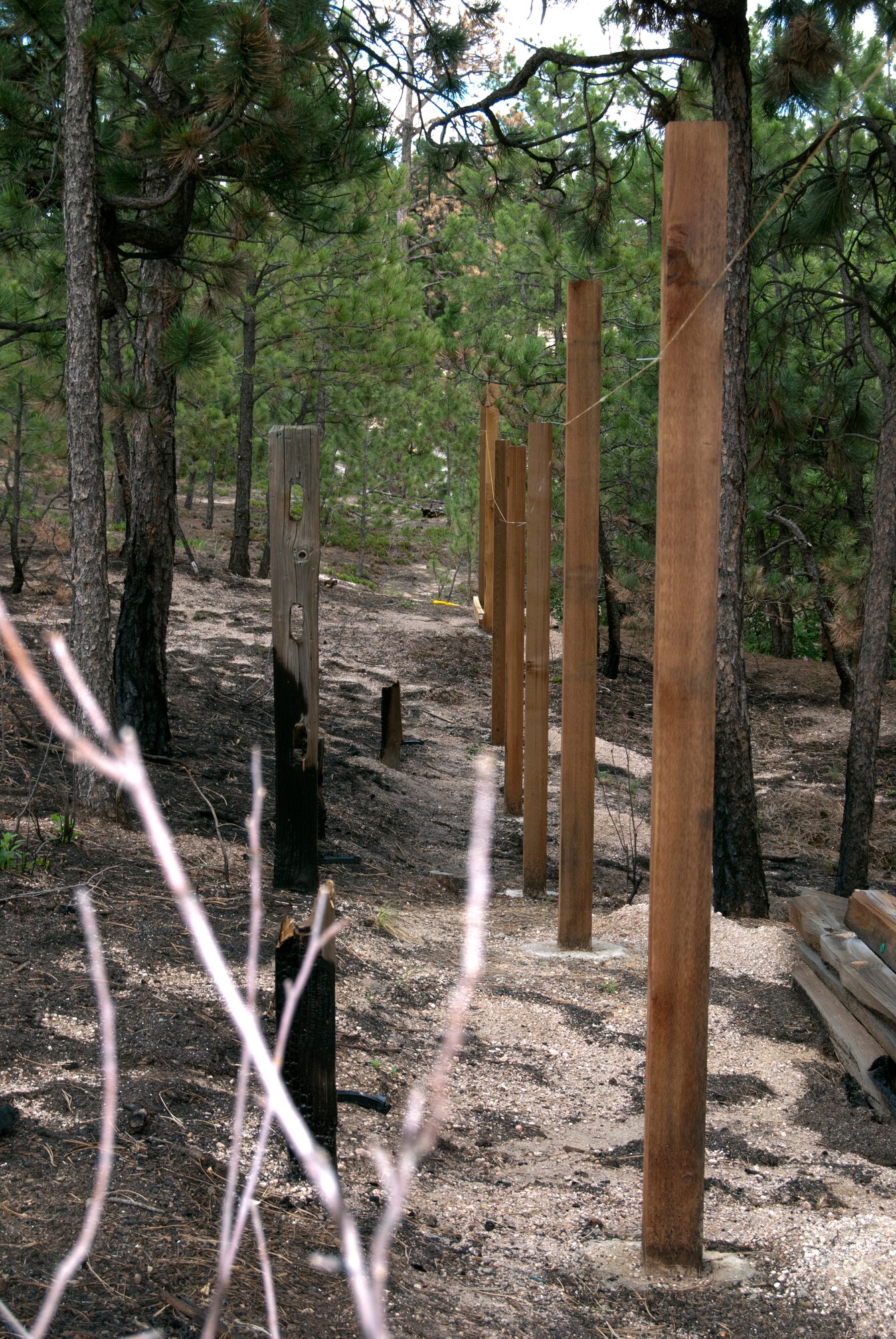 New fence posts stand on the property of Jeff and Elizabeth Miller, not far from the previous fence, which burned during the Black Forest fire in June 2013. The fire crept to within a few feet of the Millers' home, but firefighters from the Air Force Academy helped prevent any structural damage to the house itself. (U.S. Air Force photo/Don Branum)