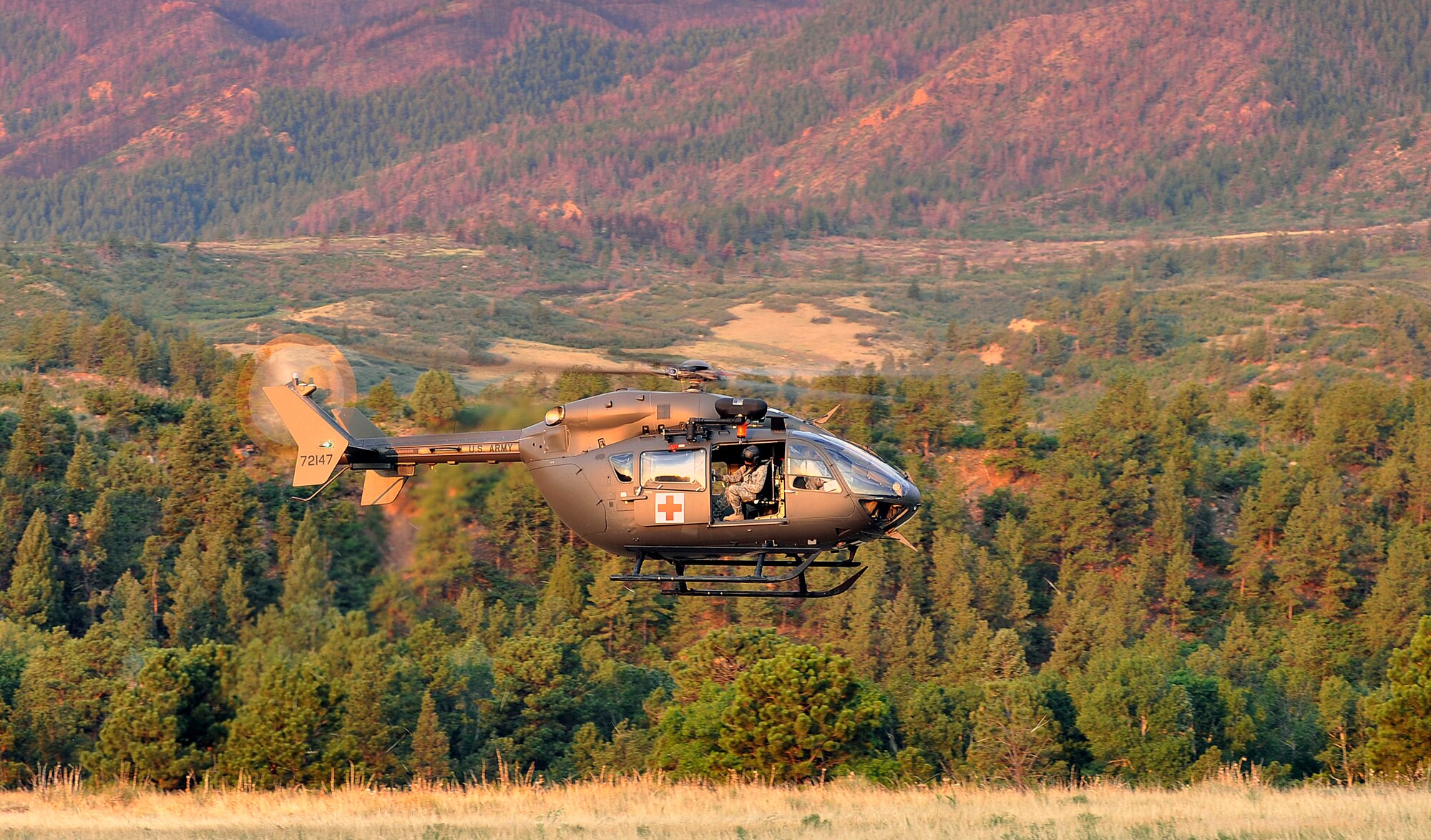 A Colorado National Guard UH-1 Iriqois descends toward a training area at the Air Force Academy July 22, 2013. First responders from the Guard, the Academy's 10th Civil Engineer Squadron and other local agencies took part in a joint exercise to test their interagency communication skills. Fires in the Colorado Springs area have killed four people, destroyed more than 800 homes and burned more than 30,000 acres of land in 2012 and 2013. (U.S. Air Force photo/Sam Lee)