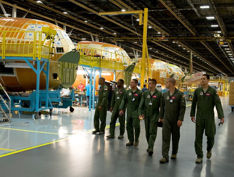 The aircrew of the final C-130J delivery to the 317th Airlift Group tours the Lockheed Martin production facility July 24, 2013, at the Lockheed Martin C-130 production line in Marietta, Ga. The crew accepted and inspected the aircraft on behalf of the 317th AG ensuring it was capable of flying and delivered safely. (U.S. Air Force photo by Airman 1st Class Peter Thompson/Released)