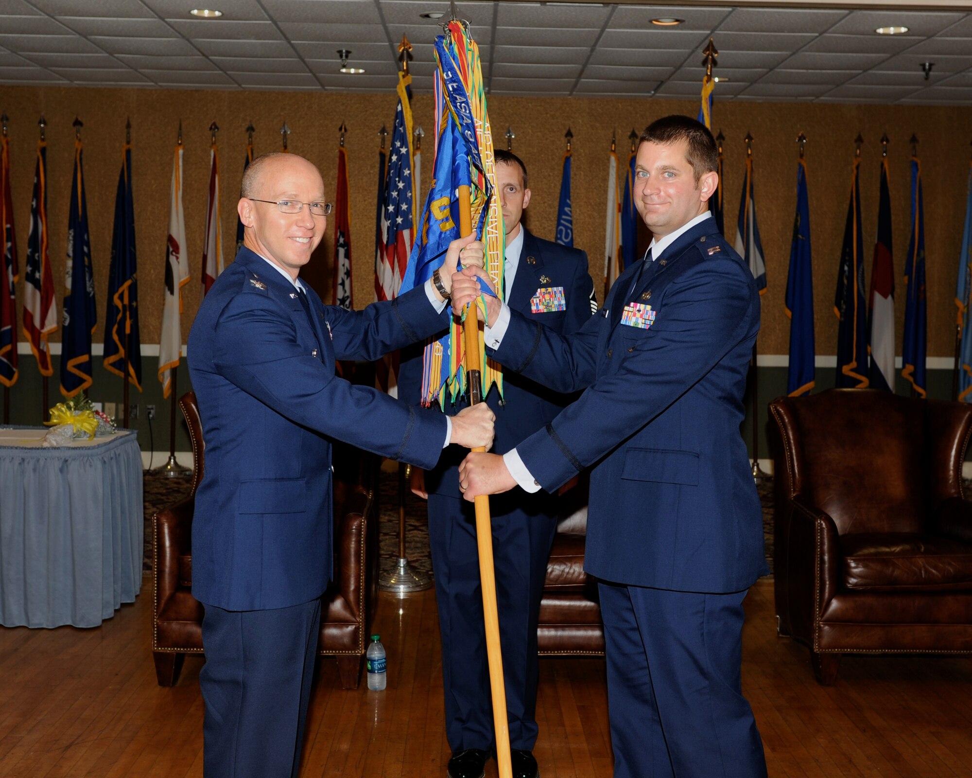 Col. David Vaughn, 14th Mission Support Group Commander, hands the 14th Security Forces Squadron guidon over to Capt. Brenton Pickrell at a formal. Pickrell came here to Columbus Air Force Base from Volkel Air Base, Netherlands, where he was the Chief of Security Forces. (U.S. Air Force Photo/ Elizabeth Owens)