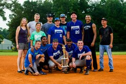 Players and fans from the 437th Maintenance Squadron pose after winning the Intramural Softball Championship Game against the 628th Security Forces Squadron July 24, 2013, at Joint Base Charleston – Air Base, S.C. 437th MXS defeated 628th SFS 14 – 11. (U.S. Air Force photo/Senior Airman George Goslin)