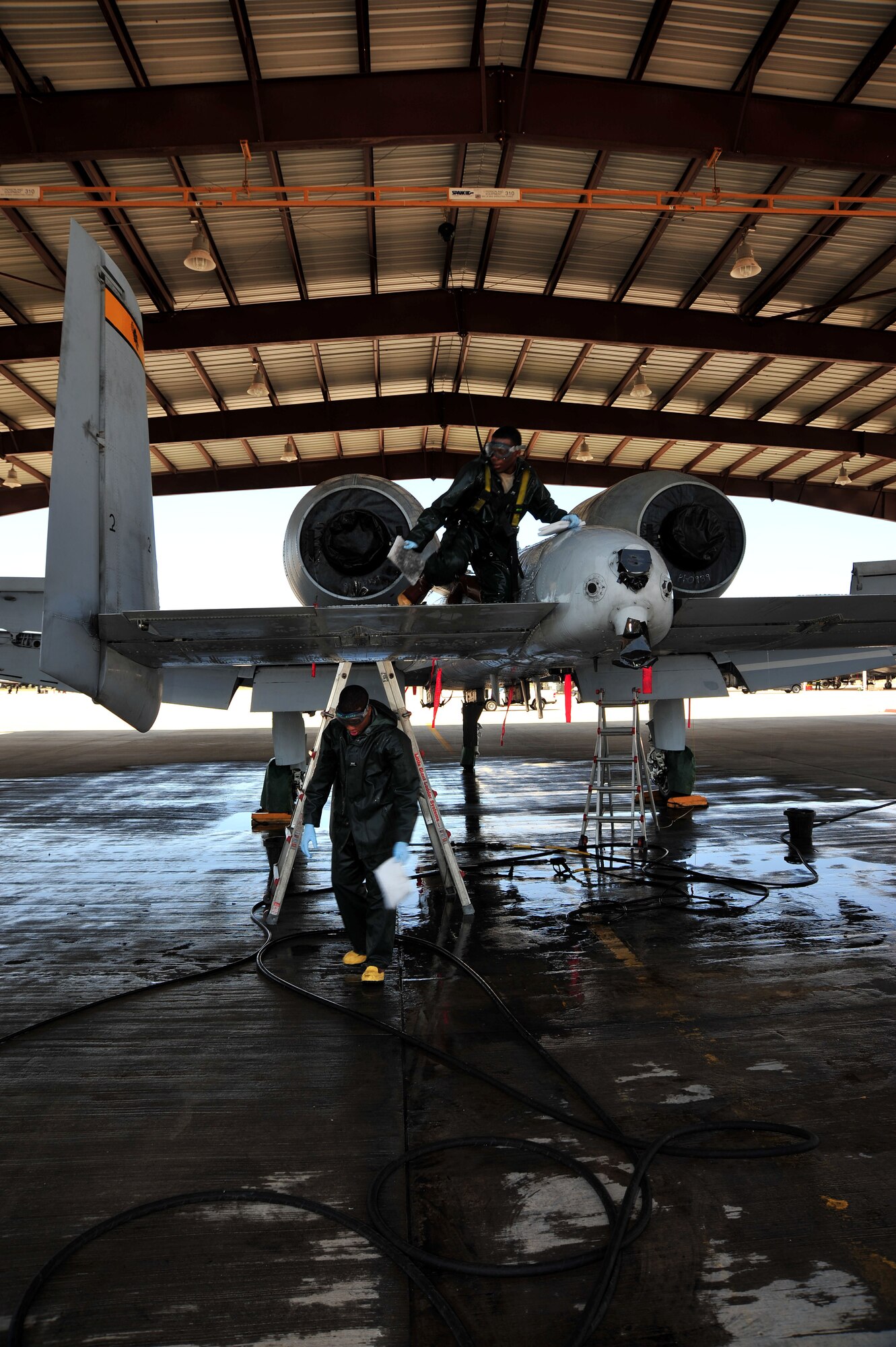 U.S. Air Force Airman 1st class Dion Smith and Airman 1st Class Brian Turman, 355th Aircraft Maintenance Squadron crew chiefs, wash an A-10 Warthog at Davis-Monthan Air Force Base, Ariz., July 23, 2013. The squadron also develops and executes a scheduled maintenance plan to maintain long term fleet health, while providing forces to support worldwide contingency taskings.(U.S. Air Force photo by Airman 1st Class Josh Slavin/Released)