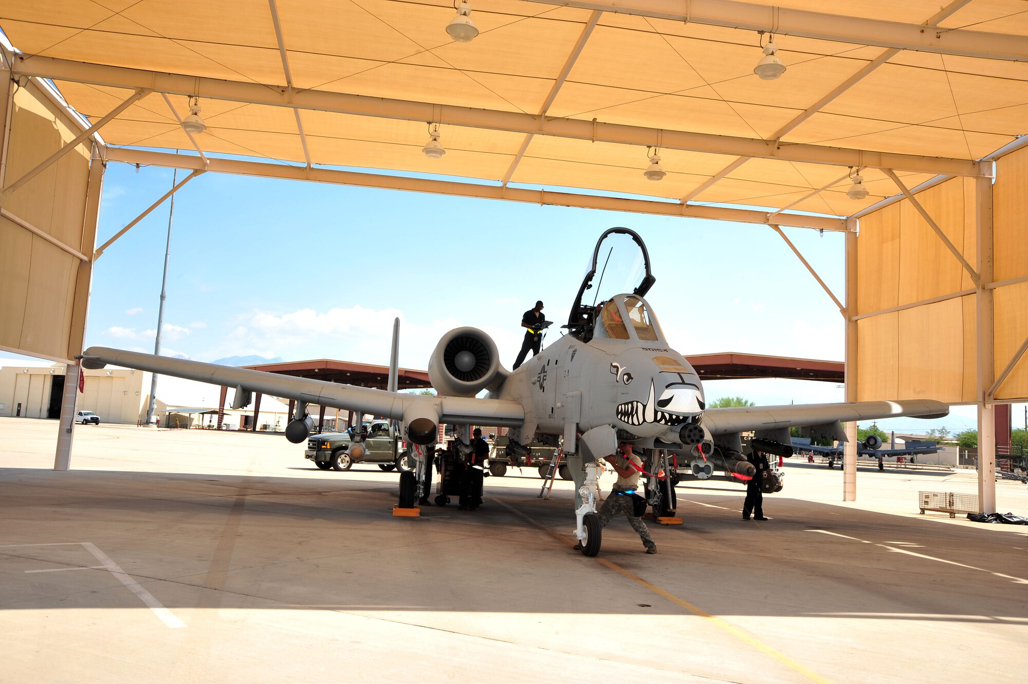 U.S. Air Force weapons troops from the 355th Aircraft Maintenance Squadron perform a post-load inspection on an A-10 Warthog at Davis-Monthan Air Force Base, Ariz., July 23, 2013. The squadron generates all combat and training sorties in the 355th Fighter Wing by managing the efforts of Airmen in 13 different specialties who maintain A-10 Warthog attack aircraft.(U.S. Air Force photo by Airman 1st Class Josh Slavin/Released)