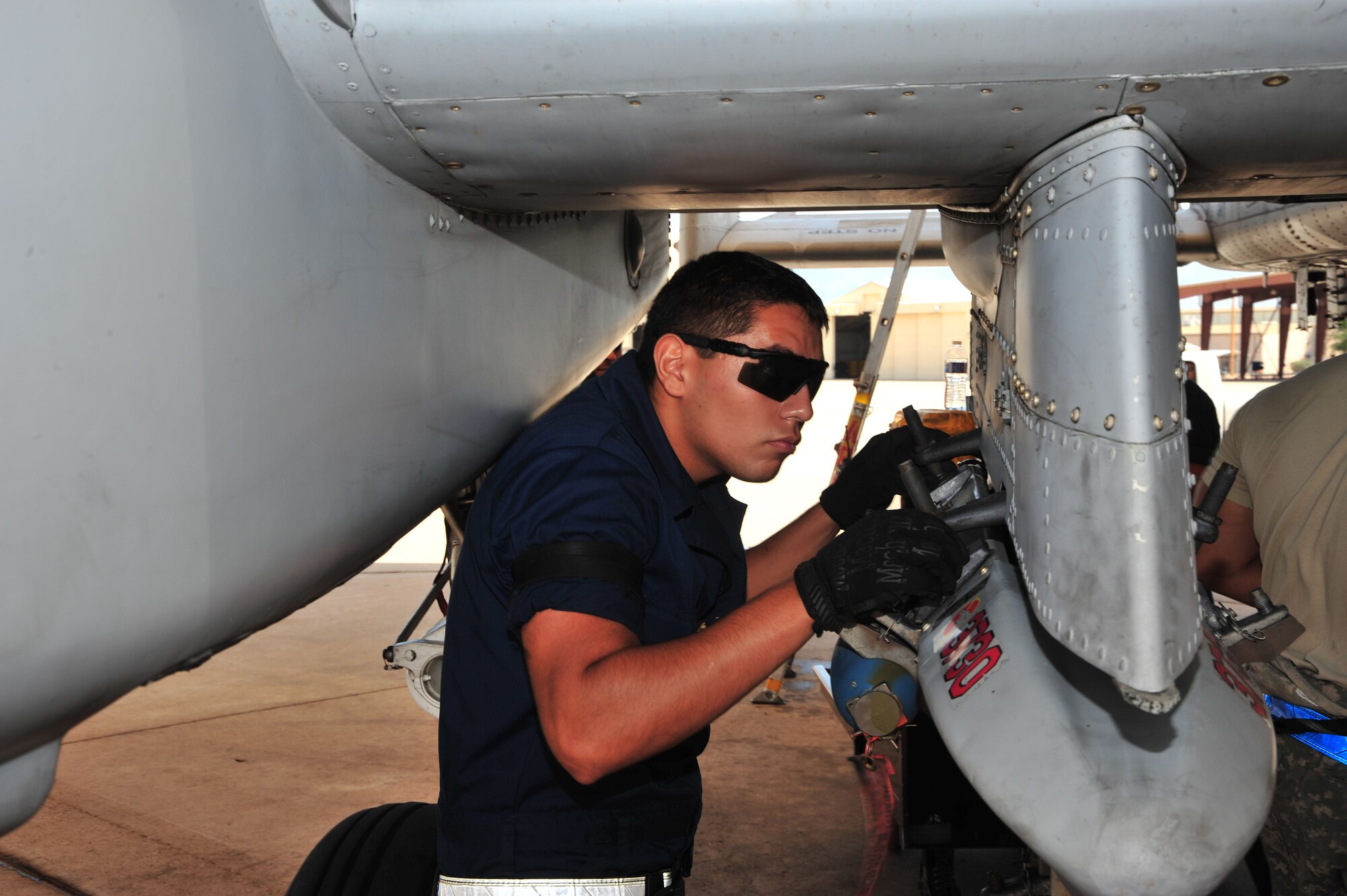 U.S. Air Force Airman 1st Class Jose Fuentes, 355th Aircraft Maintenance Squadron weapons loader, performs a post-load inspection on an A-10 Warthog at Davis-Monthan Air Force Base, Ariz., July 23, 2013. The squadron generates all combat and training sorties in the 355th Fighter Wing by managing the efforts of Airmen in 13 different specialties who maintain A-10 Warthog attack aircraft.(U.S. Air Force photo by Airman 1st Class Josh Slavin/Released)