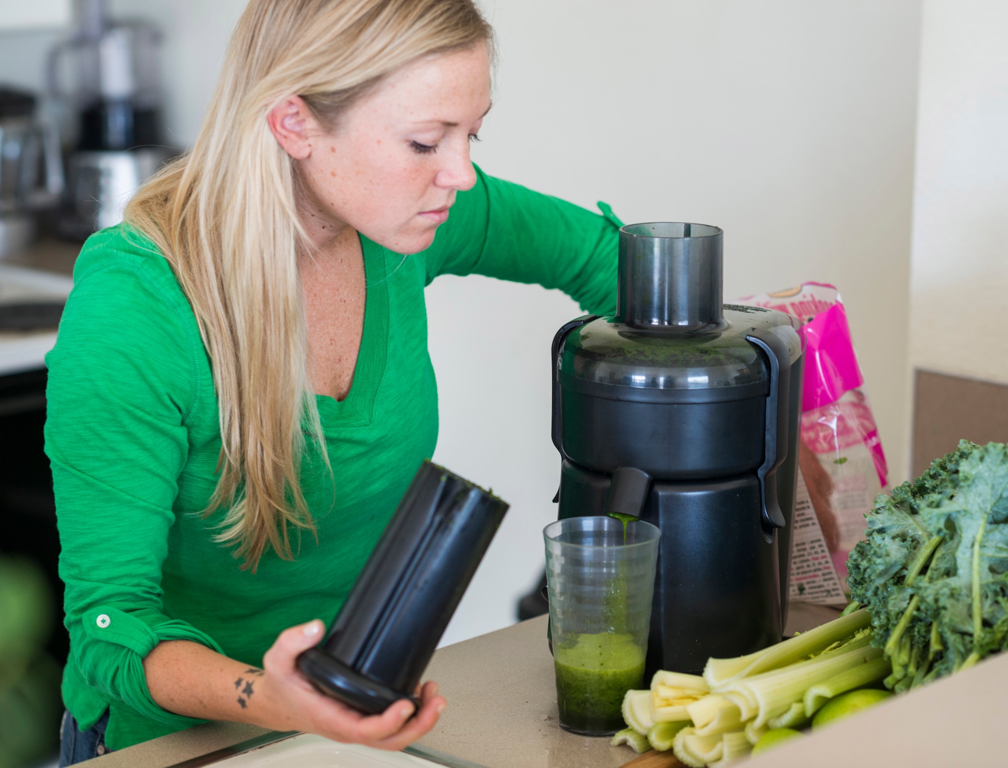 U.S. Air Force Senior Airman Megan Stanton, 366th Medical Operations Squadron medic, juices fruits and vegetables at her home in Mountain Home, Idaho, July 17, 2013. Stanton is an advocate for juicing due to the nutrient-dense quality of the resulting liquid, but also the relatively good taste she's able to acquire by adding a few fruits to the vegetable mix. (U.S. Air Force photo/Tech. Sgt. Samuel Morse)