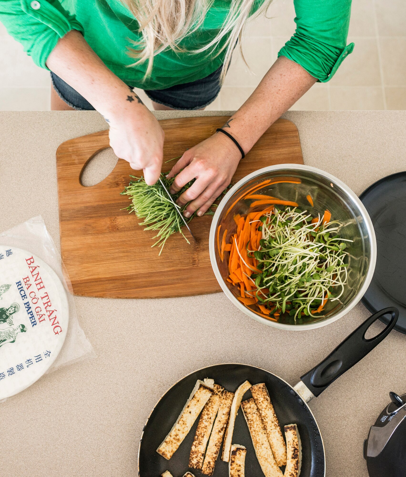 U.S. Air Force Senior Airman Megan Stanton, 366th Medical Operations Squadron medic, chops vegetables at her home in Mountain Home, Idaho, July 17, 2013. Stanton makes healthy, vegan spring rolls as light snack. (U.S. Air Force photo/Tech. Sgt. Samuel Morse)