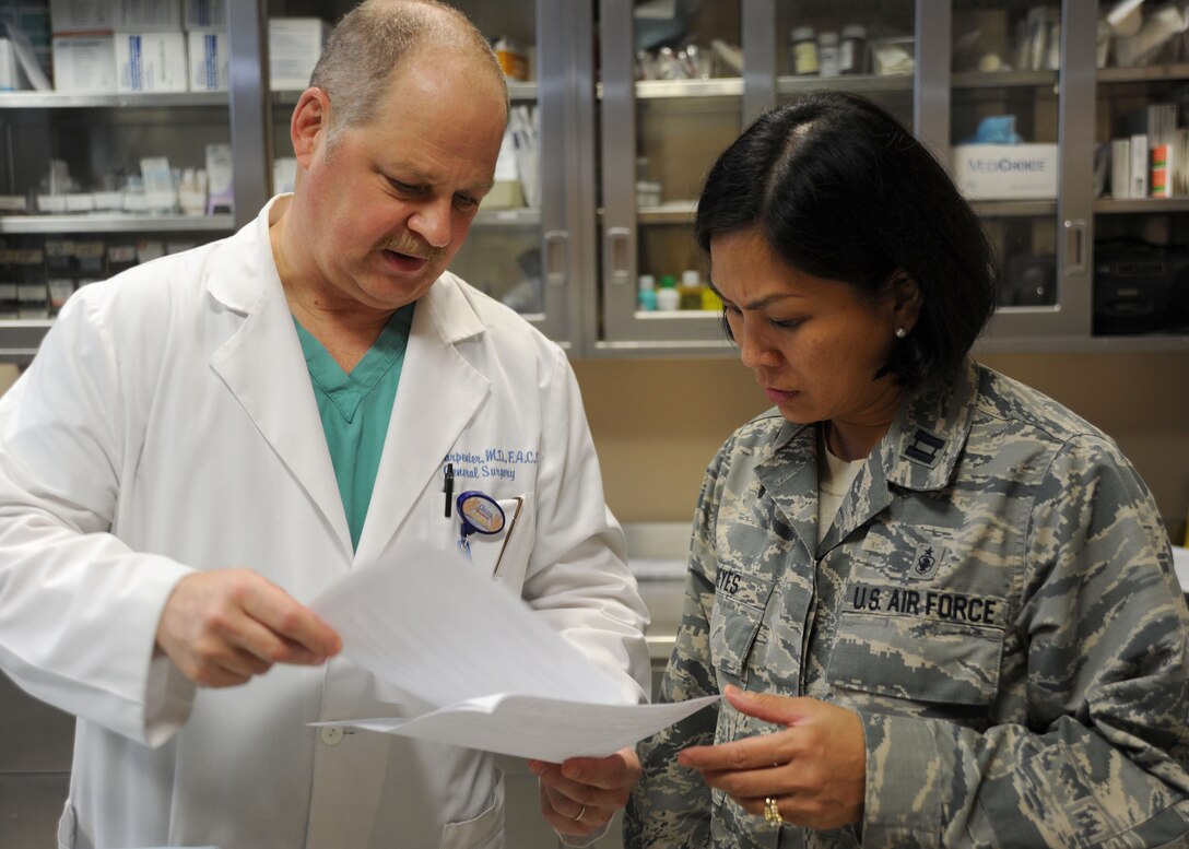 Dr. Darrell Carpenter, 779th Medical Group general surgeon, and Capt. Maria Reyes, 779th Medical Group Surgeries Specialties Flight nurse manager, discuss patient care at the Malcolm Grow Medical Clinic and Surgery Center on Joint Base Andrews, Md. The Air Force Nurse Corps celebrated their 64th Birthday on July 1, 2013. (U.S. Air Force photo Tech. Sgt. Tammie Moore)